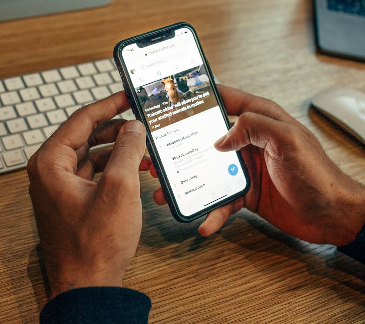 man using twitter on a phone - Is Twitter Premium Worth It
